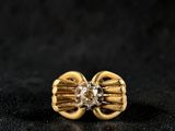 a close up of a pair of gold earrings with diamonds