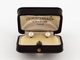 an image of a pair of pearl earrings in a black box