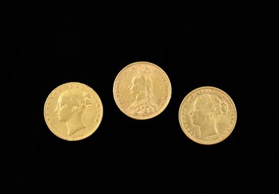 three gold coins are shown against a black background