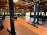 an image of a garage with two lifts in the middle of it