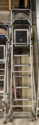 two ladders that are next to each other in a garage