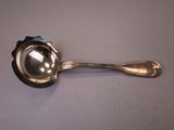 a silver spoon with a blue flower on it