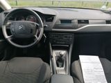 the interior of a car with a steering wheel, dashboard and dashboard controls