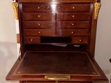 a wooden desk with a drawer on top of it
