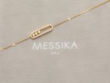 a gold plated necklace with a beaded bar on a gold chain