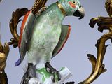 a bird that is sitting on top of a candelier