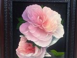 a picture of a painting of two pink flowers in a black frame