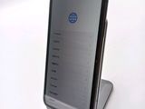 a phone that is sitting on a stand on a table
