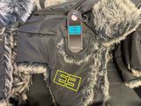 a black jacket with a fur lined hood and a pair of shoes