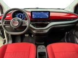 the interior of a small car with red seats and a steering wheel