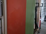 a refrigerator that is in a room with a lot of shelves