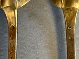 two spoons that are sitting next to each other on a table