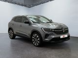 a grey car is parked in a large room