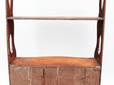 an old wooden shelf with two shelves and a door on one side