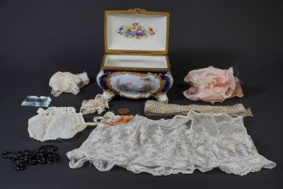 a box with lace, beads, and other items on a table