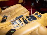 yellow leather interior of a car with controls and steering controls