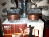 a box with three cups and a coffee pot on it