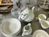 a table with a lot of dishes and cups on it