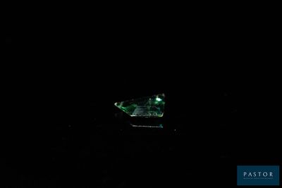 a small boat floating in the water at night