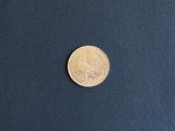 a close up of a coin sitting on top of a blue surface