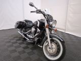 a picture of a black motorcycle parked on a black and white checkered floor