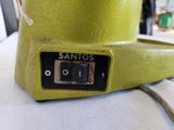 a green blender sitting on top of a white table