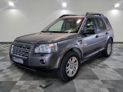 a picture of a grey land rover parked in a garage