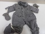 a baby boy ' s outfit and mittens on a table