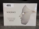 a box with a white mask on it on a table