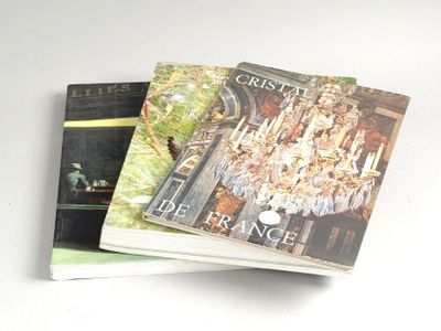 two books are stacked on top of each other on a table