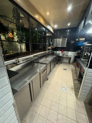 a large kitchen with stainless steel counter tops and stainless steel appliances
