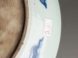 a blue and white plate with a blue design on it