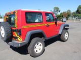 a red jeep that is parked in a parking lot