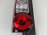 the tail light of a red car on a white surface