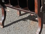 a wooden table with a bunch of black plates on top of it