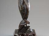 an image of a sculpture of a bird on a marble base