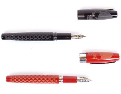 four different types of pens are lined up on a white surface