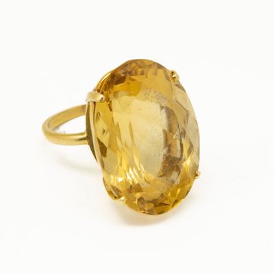 a close up of a ring with a large citrine stone in it
