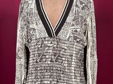 an image of a woman ' s sweater on a mannequin stand