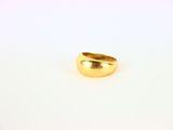 a close up of a gold ring on a white surface