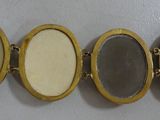 four oval mirrors are lined up against a wall