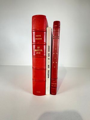 two red books sitting next to each other on a table