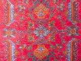 an image of a red and blue rug with a pattern on it