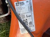 a close up of an orange mower with a tag on it