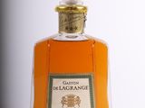 bottles of liquor are lined up on a white surface
