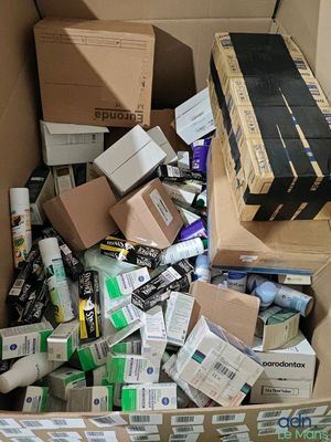 a cardboard box filled with many different types of toothbrushes