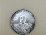 an image of a silver coin with a picture of a man on it