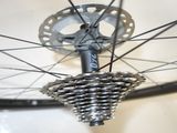 a close up of a bicycle wheel with a chain attached to it