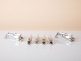 three pairs of silver cufflinks and a pair of silver cufflinks on a white surface