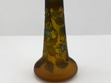 a glass vase with a design on it sitting on a table